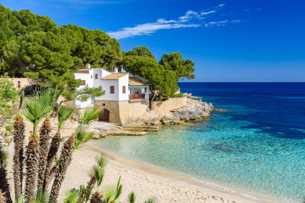 A quiet boat docked in a clear blue Mediterranean cove
